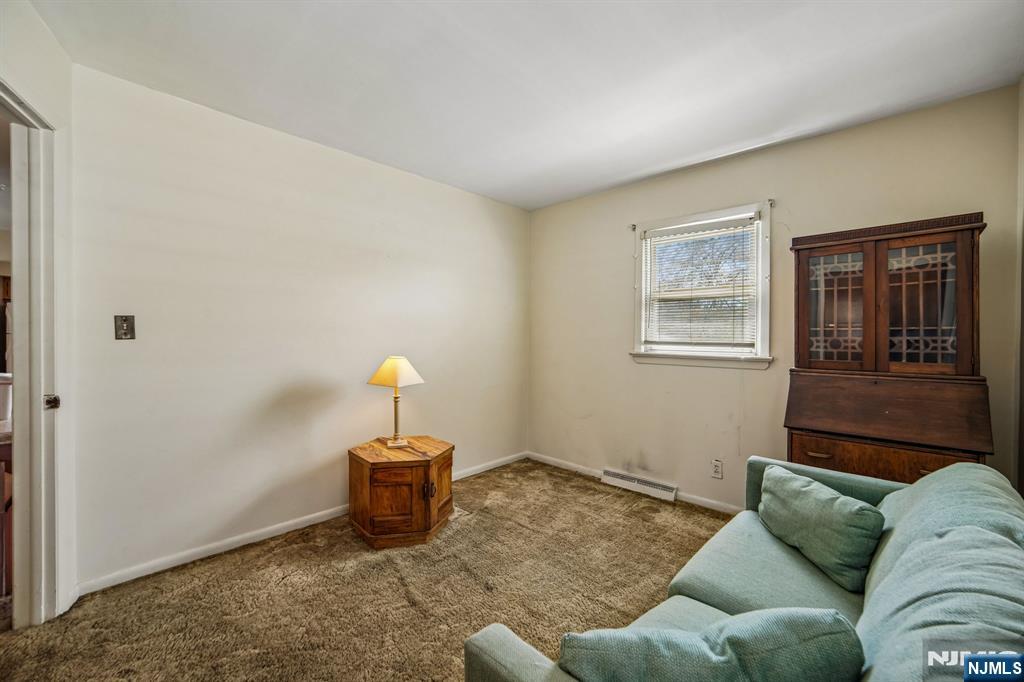 31 Division Street Bloomfield, NJ 07003 - Photo 18 of 30 a living room with furniture and a window
