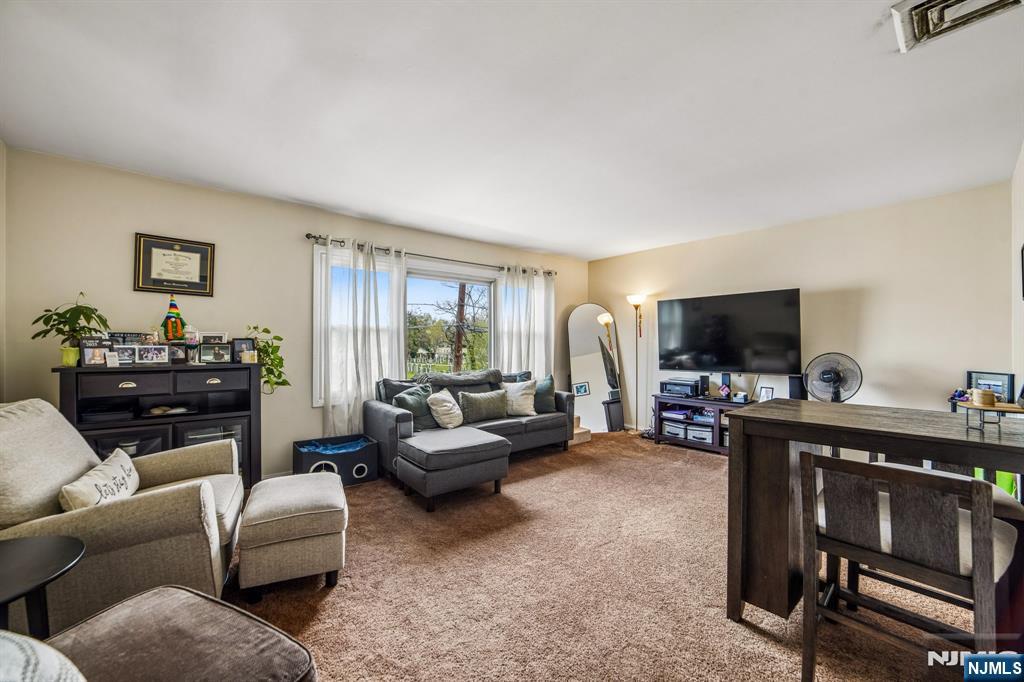 31 Division Street Bloomfield, NJ 07003 - Photo 23 of 30 a living room with furniture and a flat screen tv