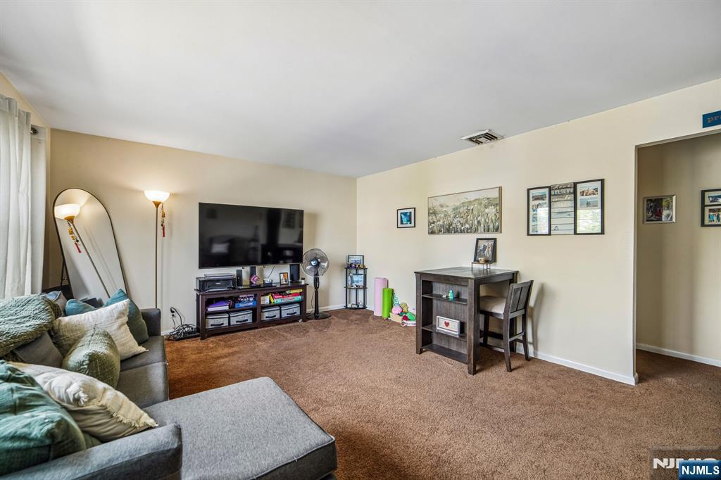 31 Division Street Bloomfield, NJ 07003 - Photo 26 of 30 a living room with furniture and a flat screen tv