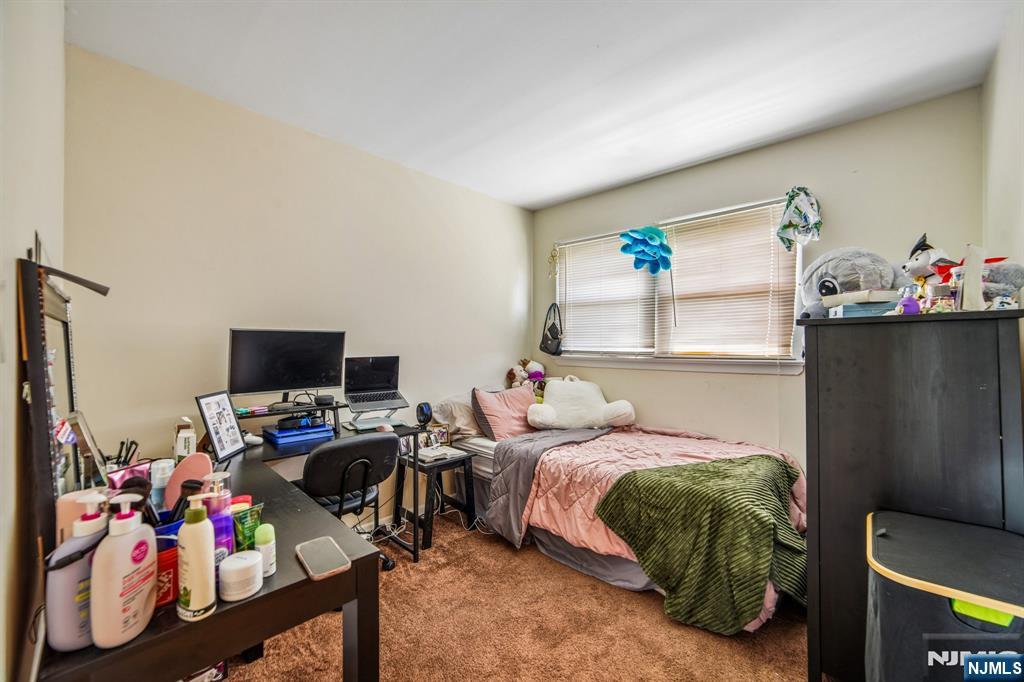 31 Division Street Bloomfield, NJ 07003 - Photo 27 of 30 a bedroom with a bed furniture and a flat screen tv