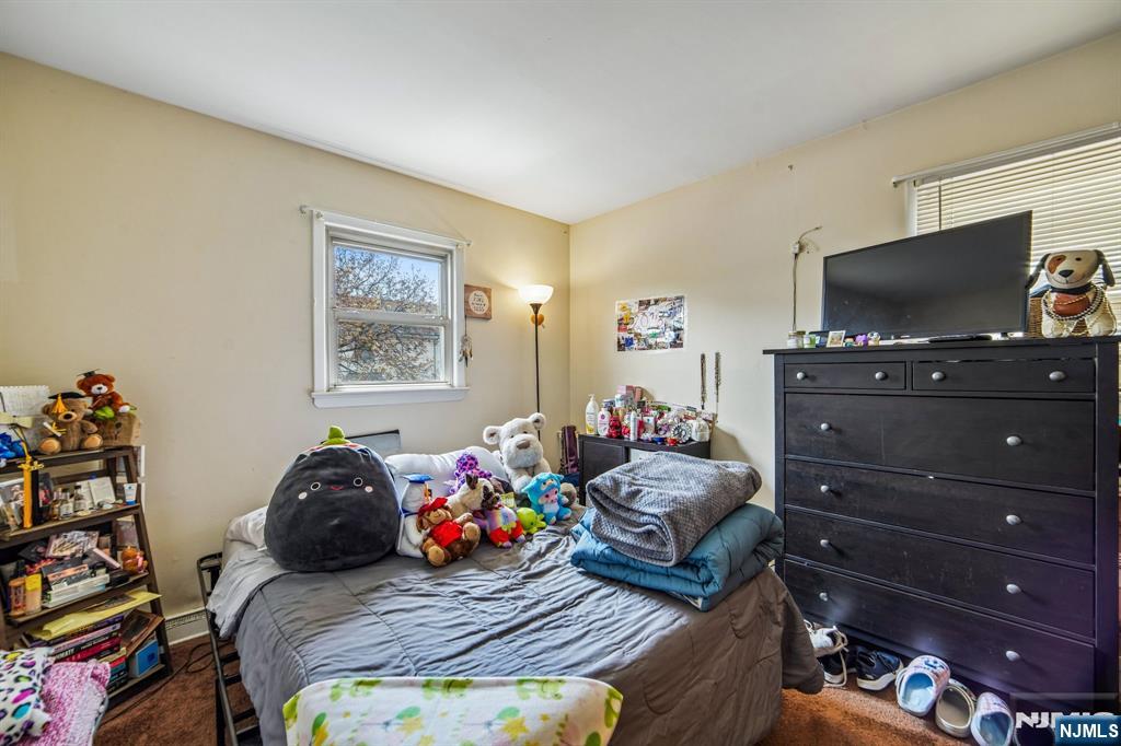 31 Division Street Bloomfield, NJ 07003 - Photo 28 of 30 a bedroom with a bed and flat screen tv