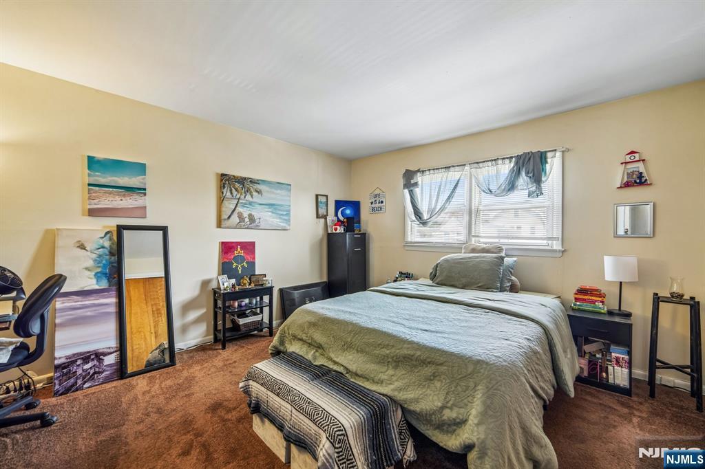 31 Division Street Bloomfield, NJ 07003 - Photo 29 of 30 a bedroom with a bed and wooden floor