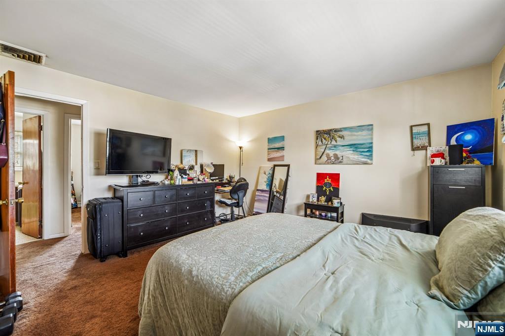 31 Division Street Bloomfield, NJ 07003 - Photo 30 of 30 a bedroom with a bed and a flat screen tv