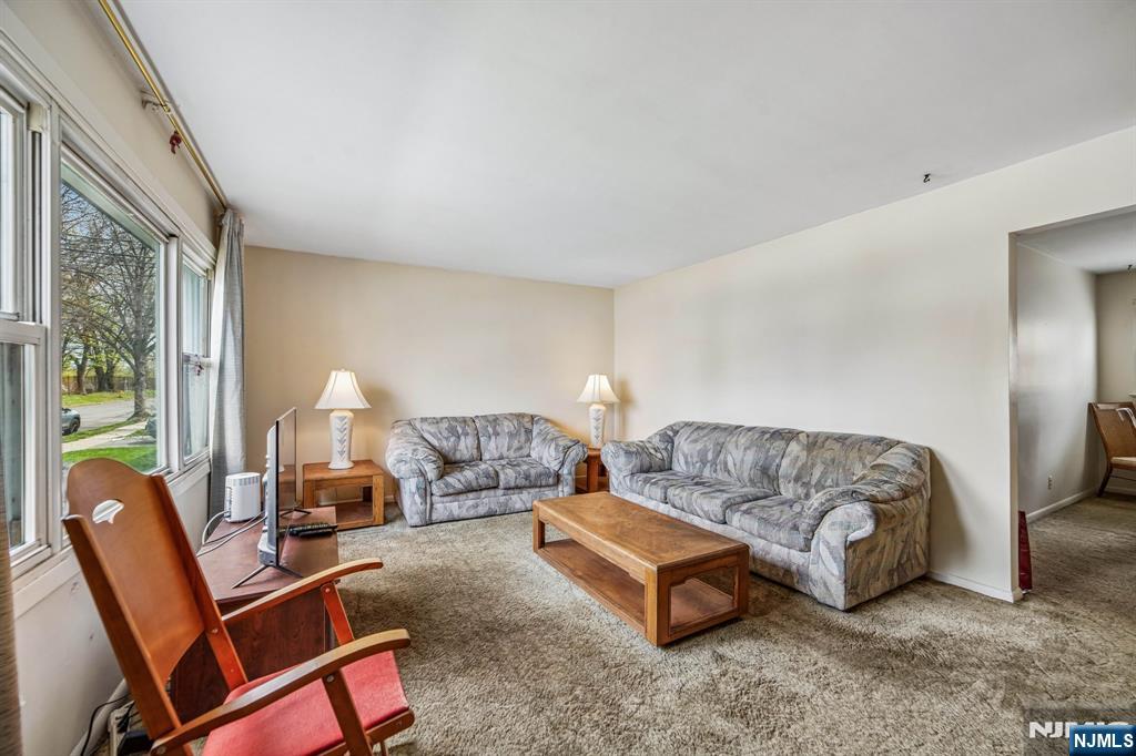 31 Division Street Bloomfield, NJ 07003 - Photo 4 of 30 a living room with furniture a large window and a lamp