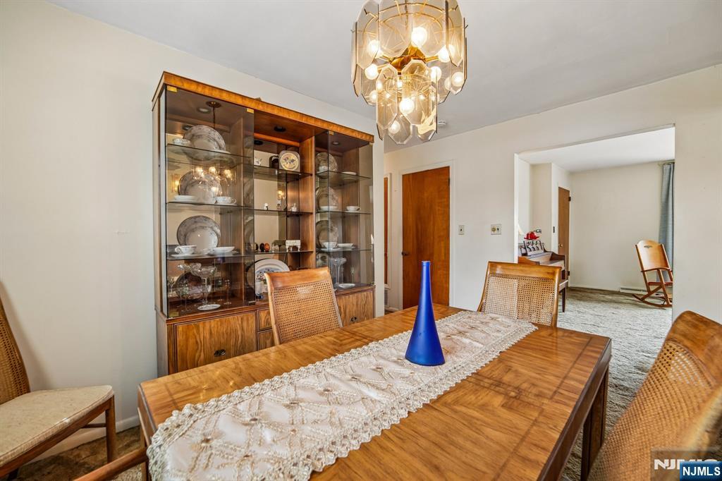 31 Division Street Bloomfield, NJ 07003 - Photo 10 of 30 a living room with stainless steel appliances furniture a chandelier and a dining table