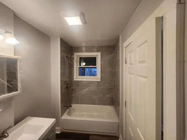 a bathroom with a bathtub and shower