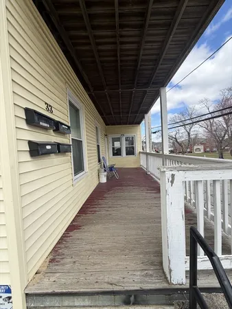 a view of a porch with wooden floor