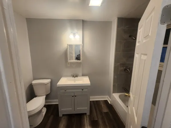 a bathroom with a toilet a sink and bathtub