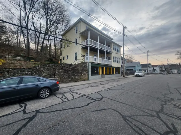 a front view of a house with a parking space