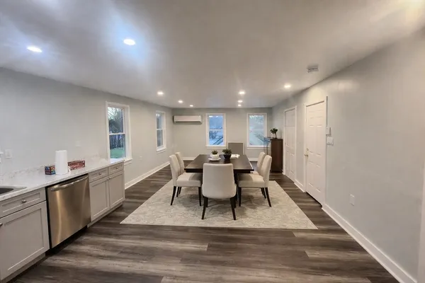 a view of a dining room with furniture window and wooden floor