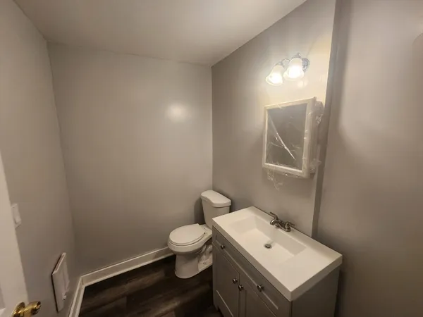 a bathroom with a toilet sink and mirror