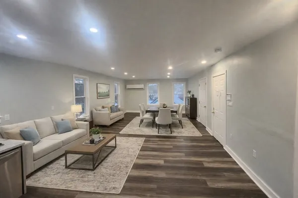 a living room with furniture and a rug