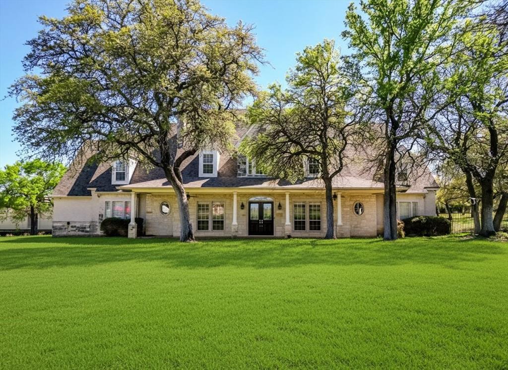 166 East Rio Ridge Azle, TX 76020 - Photo 2 of 40 a view of a house with a big yard and large trees