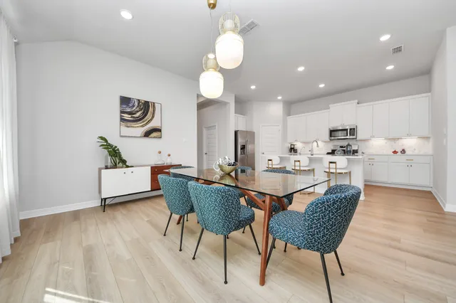 a view of a dining room with furniture and wooden floor