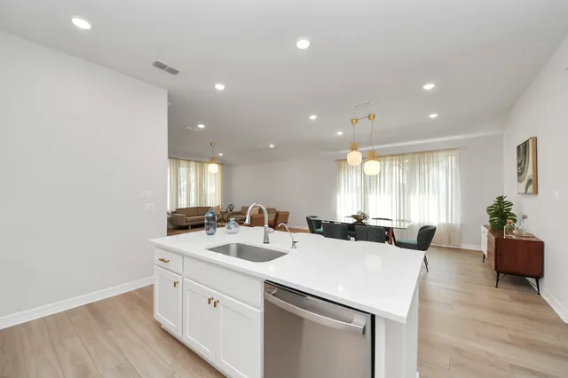a kitchen with a sink stove and refrigerator