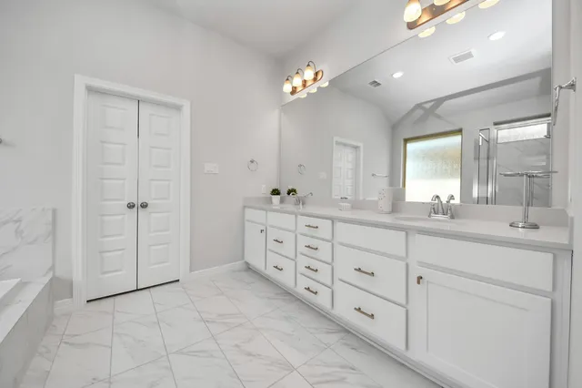 a bathroom with a bathtub and a shower