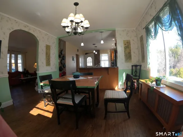 a view of a dining room with furniture window and wooden floor