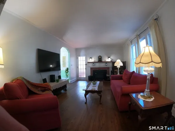 a living room with furniture a flat screen tv and a fireplace
