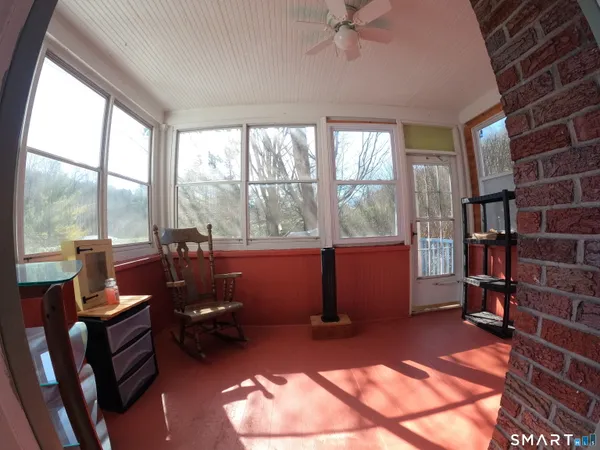 a living room with furniture a rug and a large window