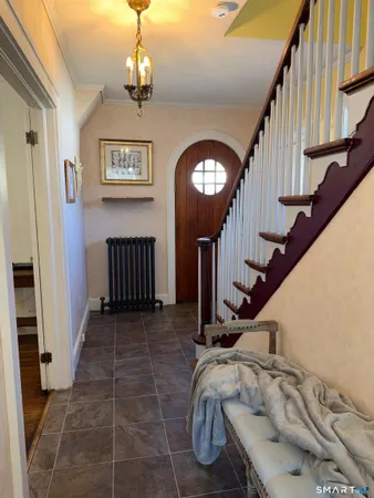 a view of entryway and hall with wooden floor