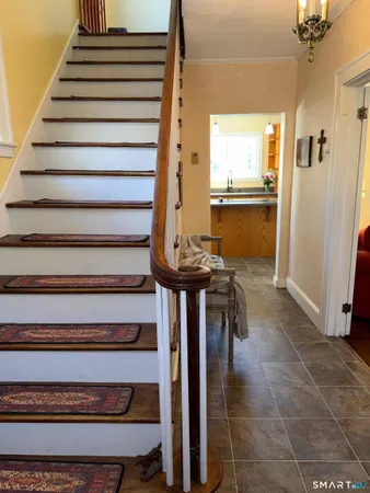 a view of entryway and hall with wooden floor