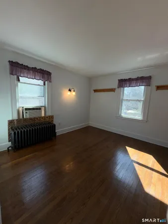 a view of front door and wooden floor