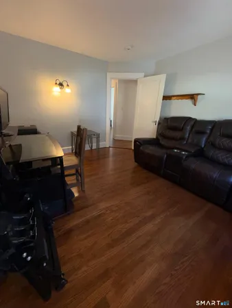 a living room with furniture and a lamp