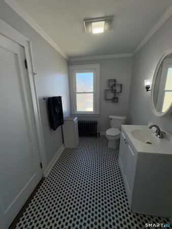 a bathroom with a sink toilet and mirror