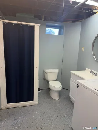 a white toilet sitting next to a bathroom sink