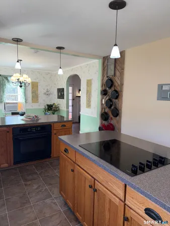 a kitchen with stainless steel appliances granite countertop a sink and a stove