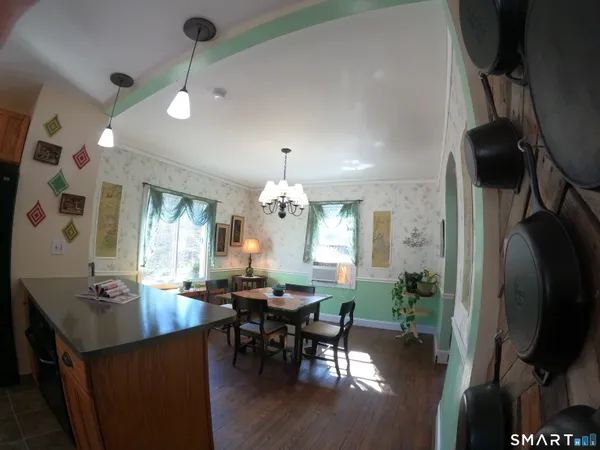 a view of a dining room with furniture and chandelier
