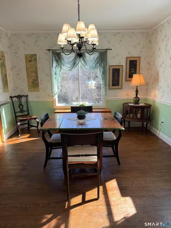 a view of a dining room with furniture and chandelier