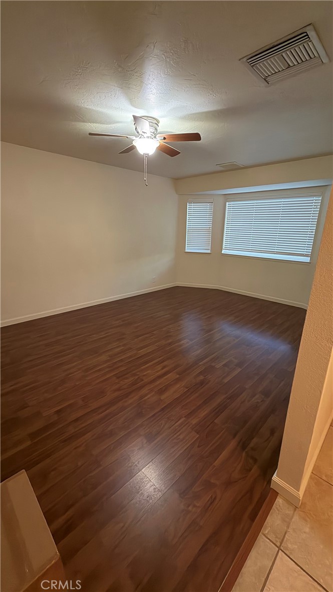 209 Kimberly Lane Ridgecrest, CA 93555 - Photo 58 of 62 a view of an empty room with wooden floor and a window