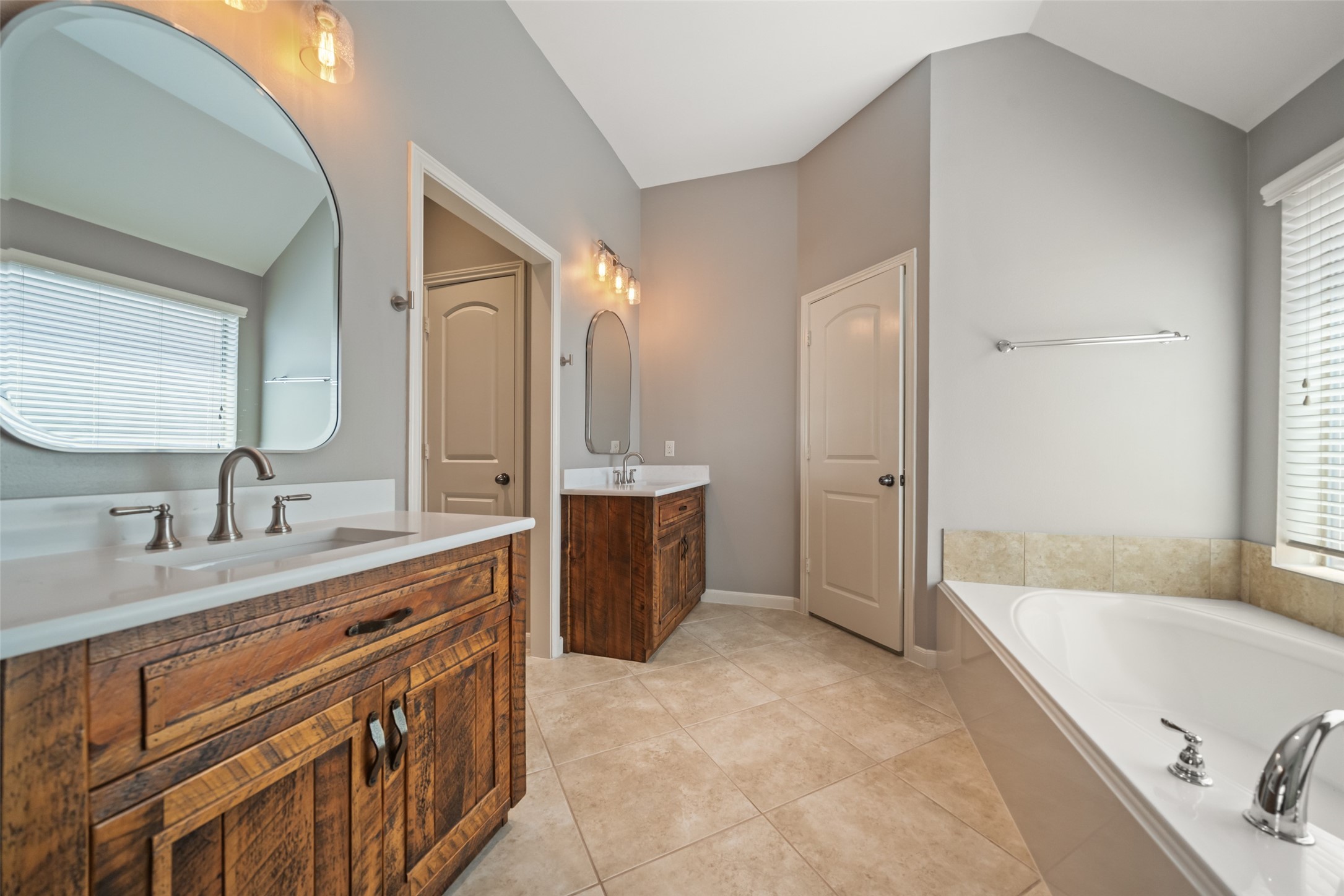 2818 Red Maple Drive Katy, TX 77494 - Photo 37 of 50 a spacious bathroom with a tub sink double vanity granite tub shower and mirror