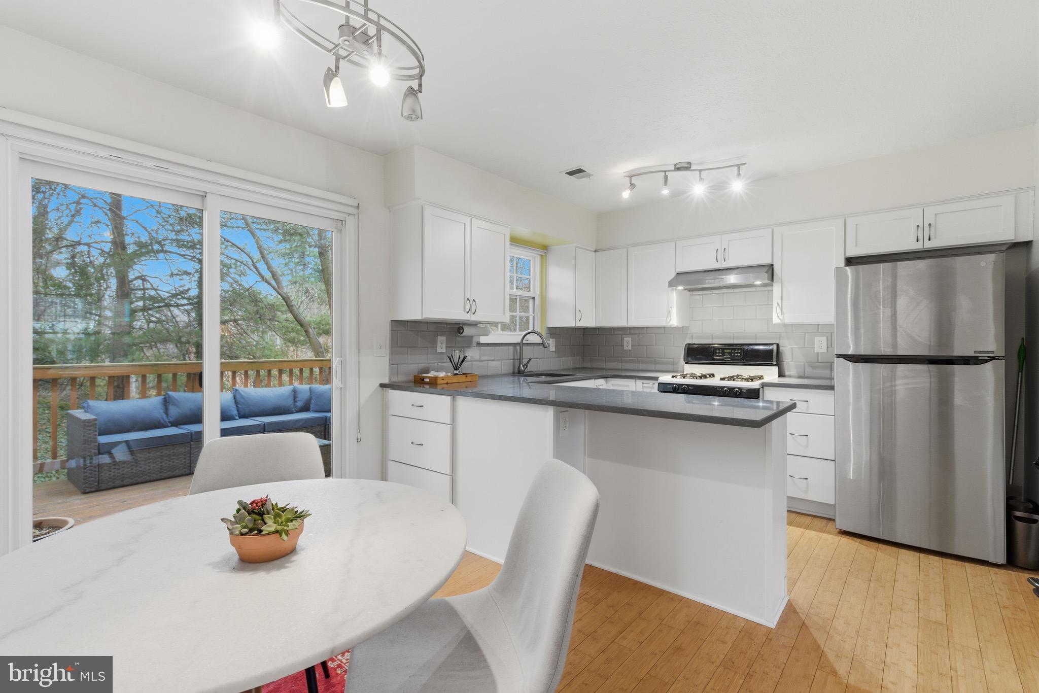 517 Pickwick Village Way Silver Spring, MD 20901 - Photo 8 of 39 a kitchen with stainless steel appliances granite countertop a refrigerator a sink a stove and white cabinets