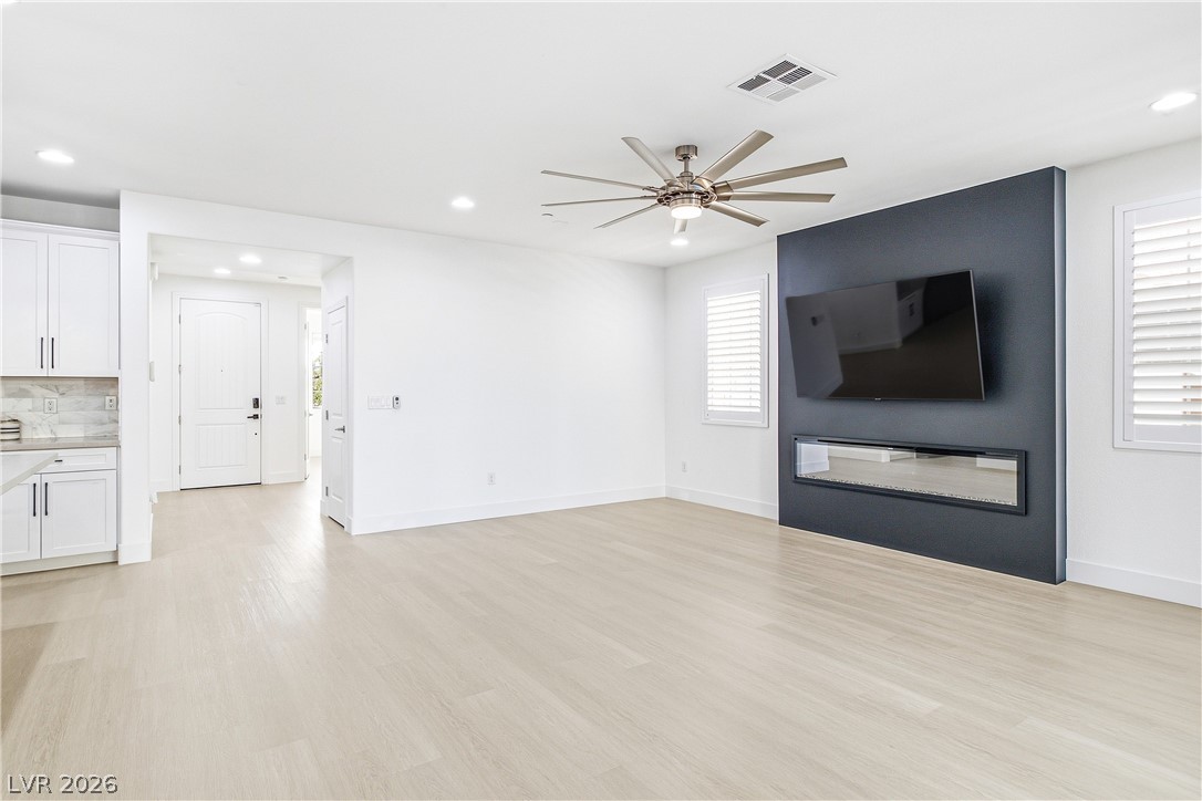 2182 Trivero Street Henderson, NV 89044 - Photo 13 of 50 Gleaming hardwood floors and a modern linear fireplace anchor this open living area.