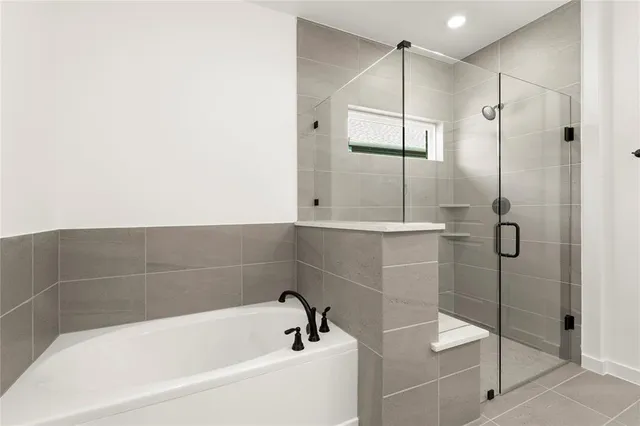 a bathroom with a bathtub and shower