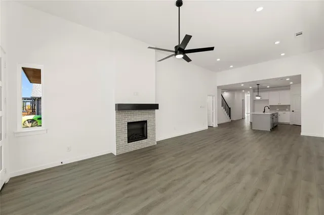 a view of empty room with wooden floor and fireplace