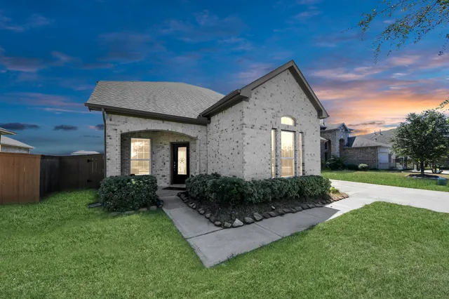 an aerial view of a house with a garden and lake view