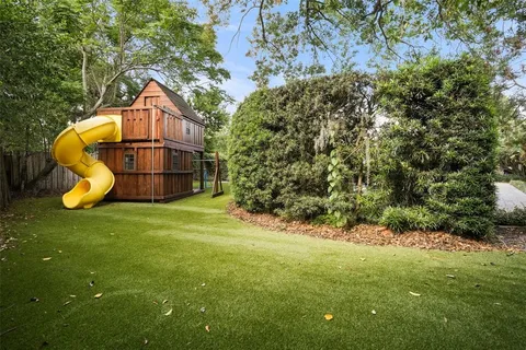 a house is sitting in middle of the green field