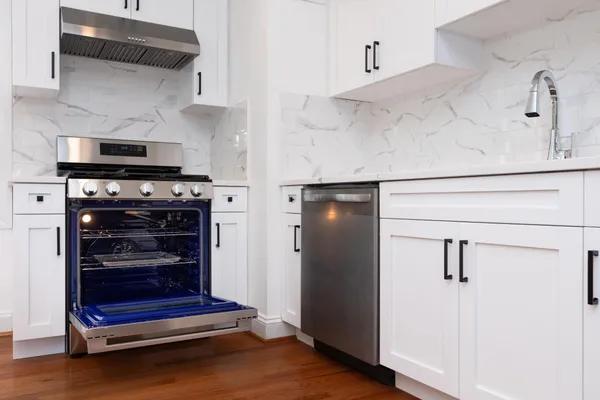 a kitchen with stainless steel appliances a stove and a refrigerator