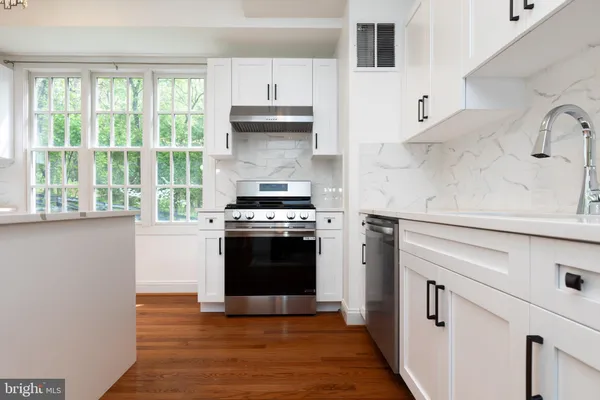 a kitchen with granite countertop a stove and a refrigerator