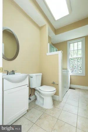 a bathroom with a toilet a sink and a mirror