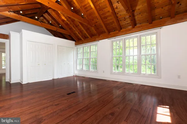 a big room with wooden floor and windows