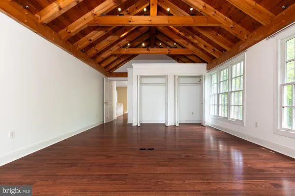 a big room with wooden floor and windows