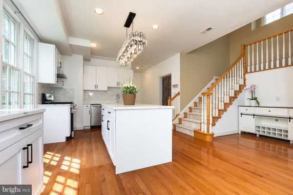 a view of kitchen with cabinets and wooden floor