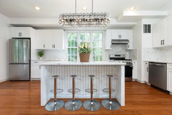 a kitchen with cabinets and wooden floor