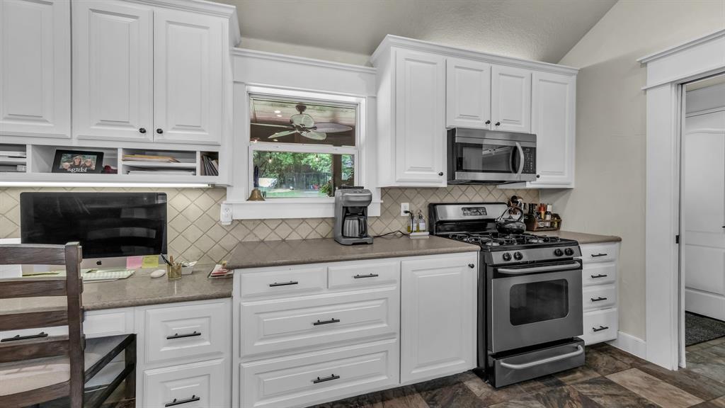 2691 Farm To Market Road 730 North Decatur, TX 76234 - Photo 12 of 36 a kitchen with white cabinets and appliances