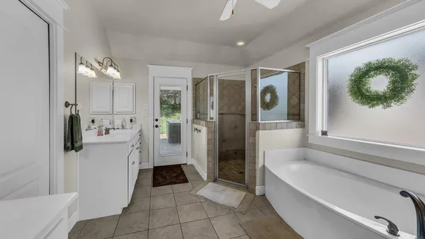 a bathroom with a bathtub and a shower