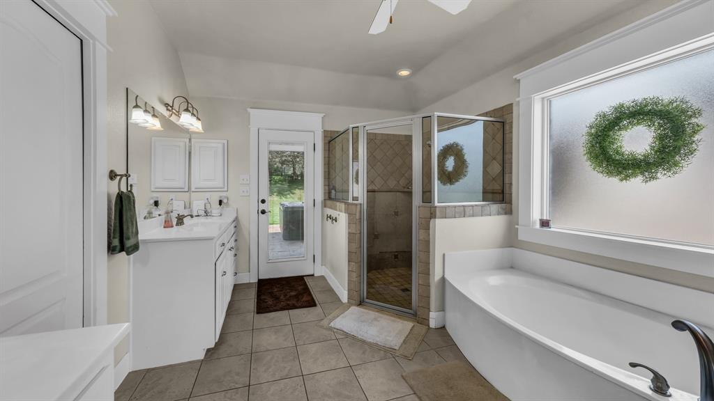 2691 Farm To Market Road 730 North Decatur, TX 76234 - Photo 18 of 36 a bathroom with a bathtub and a shower